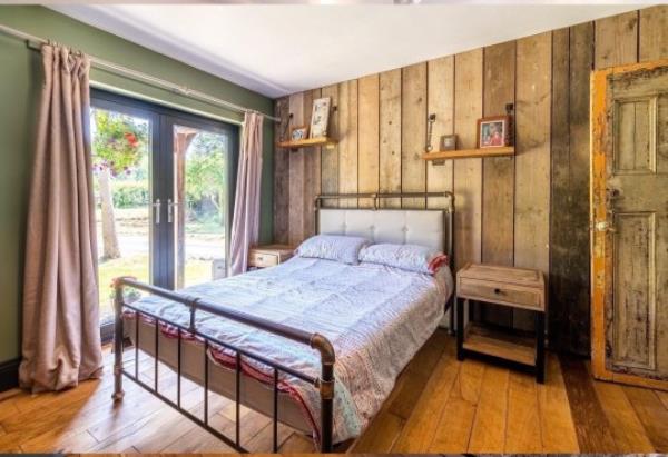 One of the bedrooms in The Haven with wood cabin plated walls. 