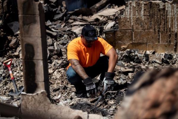 epa10795989 Lester reacts as he searches for the urn with the ashes of his son in the ruins of what o<em></em>nce was his bedroom destroyed by a wild fire in Lahaina, Hawaii, USA, 11 August 2023. At least 67 people were killed in the wildfires buring in Maui, which is co<em></em>nsidered the largest natural disaster in Hawaii's state history. EPA/ETIENNE LAURENT