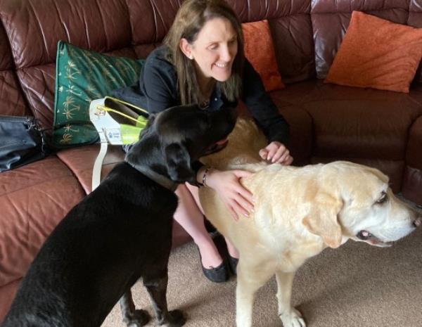 Siobhan Meade pictured with two labrador guide dogs 
