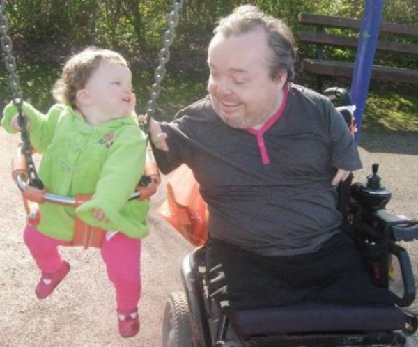 Kevin Do<em></em>nnellon with his daughter, Daisy, at a children's playground - she's on a swing and Kevin is next to her, pushing the swing.