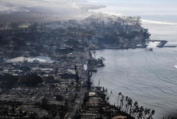 An aerial view shows destroyed homes and buildings that burned to the ground around the harbor and Front Street in the historic Lahaina Town in the aftermath of wildfires in western Maui in Lahaina, Hawaii, on August 10, 2023. 