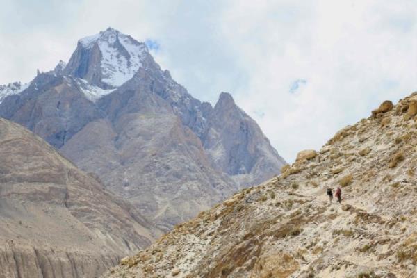 This picture taken on July 10, 2023, shows Pakistani porters hiking on the trail between Askole and K2, world's second tallest mountain in the Karakoram range of GilgitBaltistan, Pakistan. (Photo by Joe STENSON / AFP) (Photo by JOE STENSON/AFP via Getty Images)